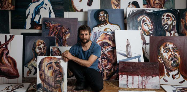 Ben Quilty with Myuran Sukumaran's paintings (photo by Daniel Boud)