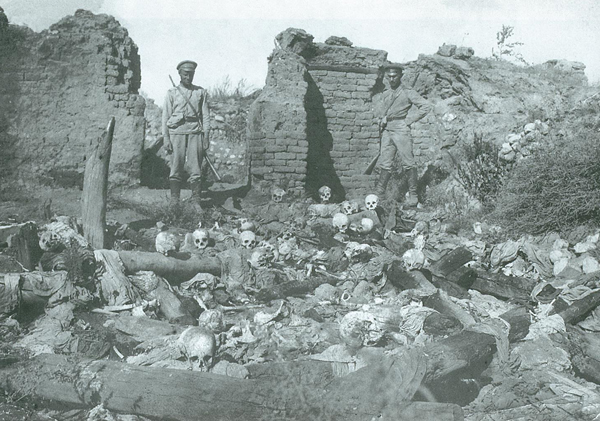 Russian soldiers contemplating the remains of a massacre of Armenian villagers in the Mush province
