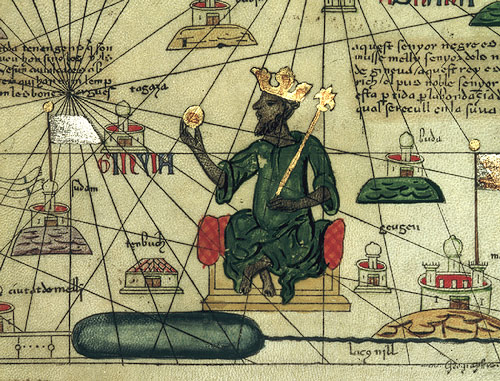 Depiction of Mansa Musa, ruler of the Mali Empire in the 14th century, from a 1375 Catalan Atlas of the known world (mapamundi), drawn by Abraham Cresques of Mallorca. Musa is shown holding a gold nugget and wearing a European-style crown (via Wikimedia Commons)