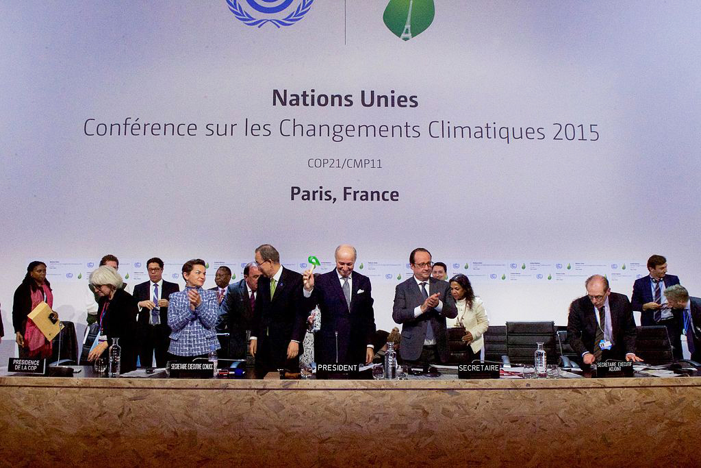 French Foreign Minister Laurent Fabius bangs down the gavel on December 12, 2015, after representatives of 196 countries approved a environmental agreement during a multinational meeting at LeBourget Airport in Paris, France (photo by U.S. Department of State/Wikimedia Commons)