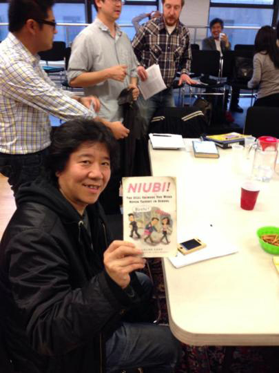 Meng Jingui holding a copy of Niubi by Eveline Chao - photograph by Nick Frisch